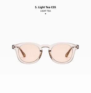 Detail view of oval light tea sunglasses with high-quality transparent resin frame