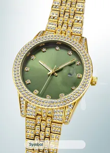 Detail of gold iced-out men's watch featuring a green sunray dial and date window