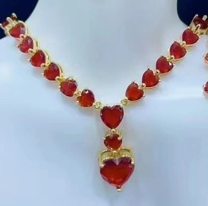 Elegant summer ruby style jewelry set with red heart gems on a golden necklace