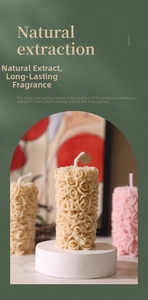 Detailed view of handmade rose column scented candle with elegant floral relief carving