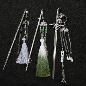 Sword-shaped hair sticks with lotus tassels and jade beads in traditional Chinese style