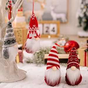 Set of four knitted Christmas gnomes with long white beards and festive hanging ropes