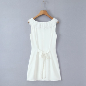 Detail of white sleeveless mini dress featuring lace neckline and elegant back bow tie