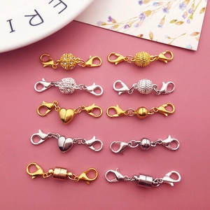 Detail of assorted gold and silver magnetic lobster clasps in ball and cylinder shapes