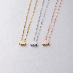 Three mirror-polished cloud pendants in gold, silver, and rose gold on O-chains