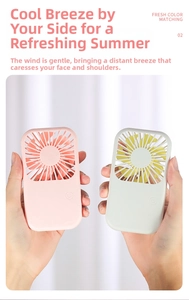 Detail showing pink and green portable mini fans with safety grille and power button