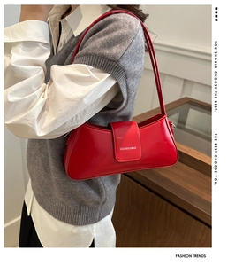Fashionable red leather underarm bag worn by a model in a professional casual setting