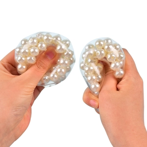 Colorful clear stress relief squeeze ball with white pearls inside on white background