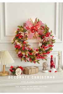 Close-up of a 50cm Christmas wreath with red berries and LED lights on a white fireplace