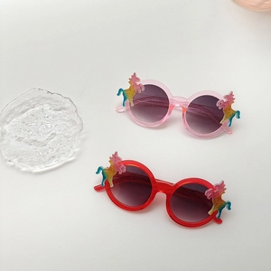 Close-up of kids unicorn sunglasses featuring colorful embossed unicorn temples on round frames