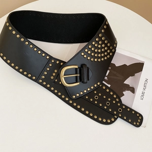 Detail of black wide faux leather belt featuring rows of vintage golden punk metal studs