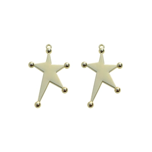Close-up of golden irregular eight-pointed star charms with metal loops for DIY jewelry
