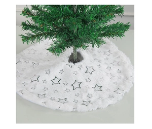 Close-up of white plush Christmas tree skirt with silver foil star pattern on the base