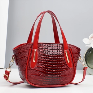 Elegant red crocodile pattern handbag with gold hardware and removable shoulder strap