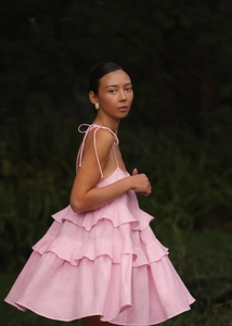 Close-up of light pink tiered ruffle mini dress with adjustable spaghetti straps