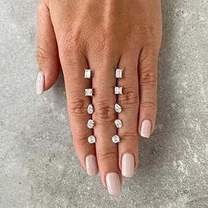 Vertical display of 925 silver stud earrings set in five geometric crystal shapes