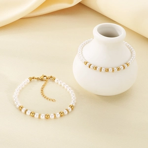 Detail showing baroque pearl and 18K gold bead bracelet with adjustable chain detail