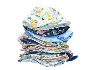 Stack of baby sun hats featuring colorful cartoon patterns like trucks and whales