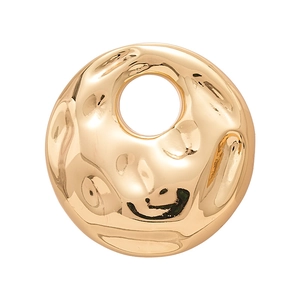 Modern golden round brooch with hammered texture and central cutout in a minimalist style