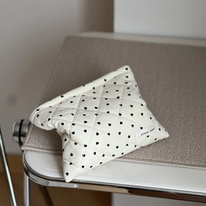 Quilted corduroy makeup bag in cream with black heart patterns and simple wish label