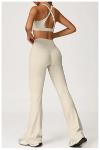 Detail of high-waisted yoga flare pants with side pockets and criss-cross back sports bra