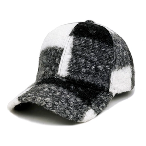 Close-up of thick checkered teddy fleece fabric on a warm winter baseball cap