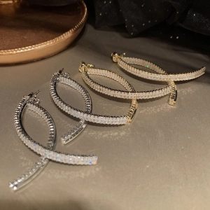 Sparkling zircon tassel earrings in gold and silver finish with elegant infinity loop design