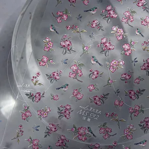 Macro detail of MS 592 embossed 5D nail stickers with pink flowers and blue birds