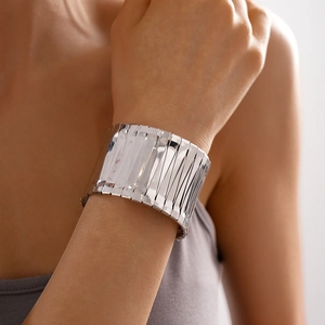 Detailed view of silver wide cuff bangle featuring a unique vertical pleated metal texture