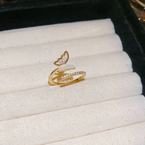 Macro shot of butterfly ring featuring white shell inlay and sparkling cubic zirconia details