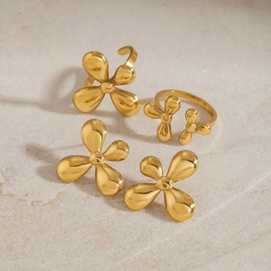 Golden titanium steel four-petal flower ring and earrings set on light stone