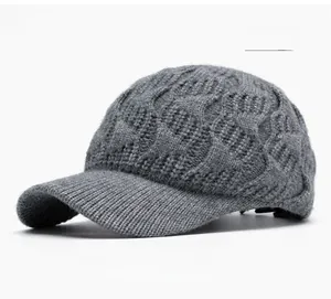 Detailed view of the dark grey thick knit texture and wide brim of the winter baseball cap