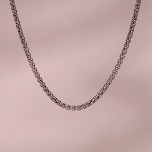 Macro view of polished silver stainless steel box chain necklace with smooth metal links