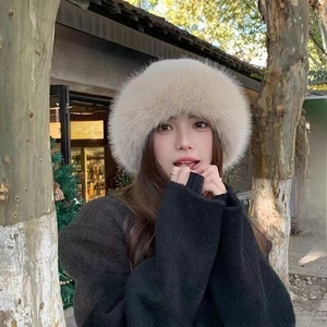 Close-up of a cozy beige faux fur Russian style hat worn outdoors in winter street