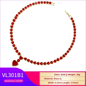 Detail view of a gold heart tennis necklace with red stones and product measurements