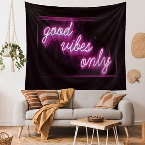 Detail of Good Vibes Only neon print tapestry styled above a sofa for wall decor