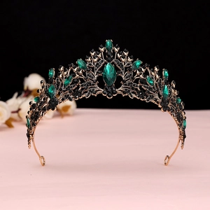 Detail of baroque bridal crown with emerald green stones and bronze vintage metal frame