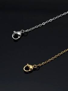 Macro detail of 18K gold and silver stainless steel O-chains with secure lobster clasps