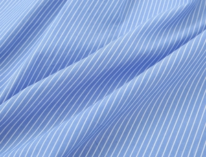 Macro detail of high-quality blue and white pinstripe cotton fabric with natural texture