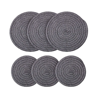 Set of 6 heat-resistant grey woven cotton coasters in a minimalist circular design