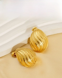 Macro view of water-drop shell earrings with 18K gold-plated spiral texture