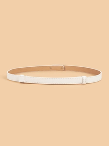 Detail of white Saffiano leather skinny belt with metal rivets on peach background