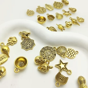 Assorted vintage gold alloy peanut and shell pendants for DIY jewelry making
