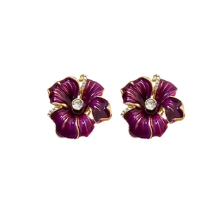 Vintage style purple enamel flower earrings with gold frame and crystal center on white