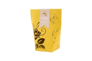 Detailed view of yellow wedding candy box with gold floral foil and Thank You tag
