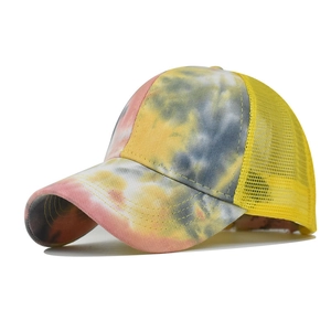 Detail showing colorful tie-dye patterns and yellow mesh fabric on a breathable sun hat