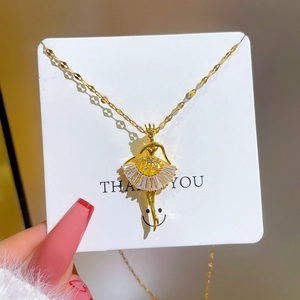 Elegant gold titanium steel necklace featuring a zircon ballet dancer pendant on a display card