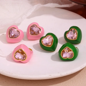 Macro shot of 18K gold plated heart rings with pink crystals and enamel finish