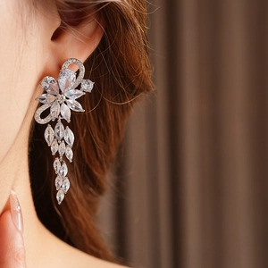 Close-up of model wearing silver flower tassel earrings with sparkling zircon crystals