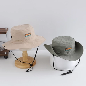 Detail of outdoor sun hats with side buttons and adjustable windproof drawstring